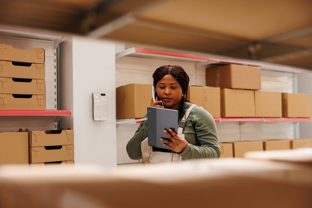 African american worker talking at landline phone